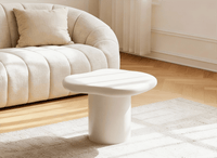 Table basse ronde en béton brossé blanc plateau asymétrique ZELINE